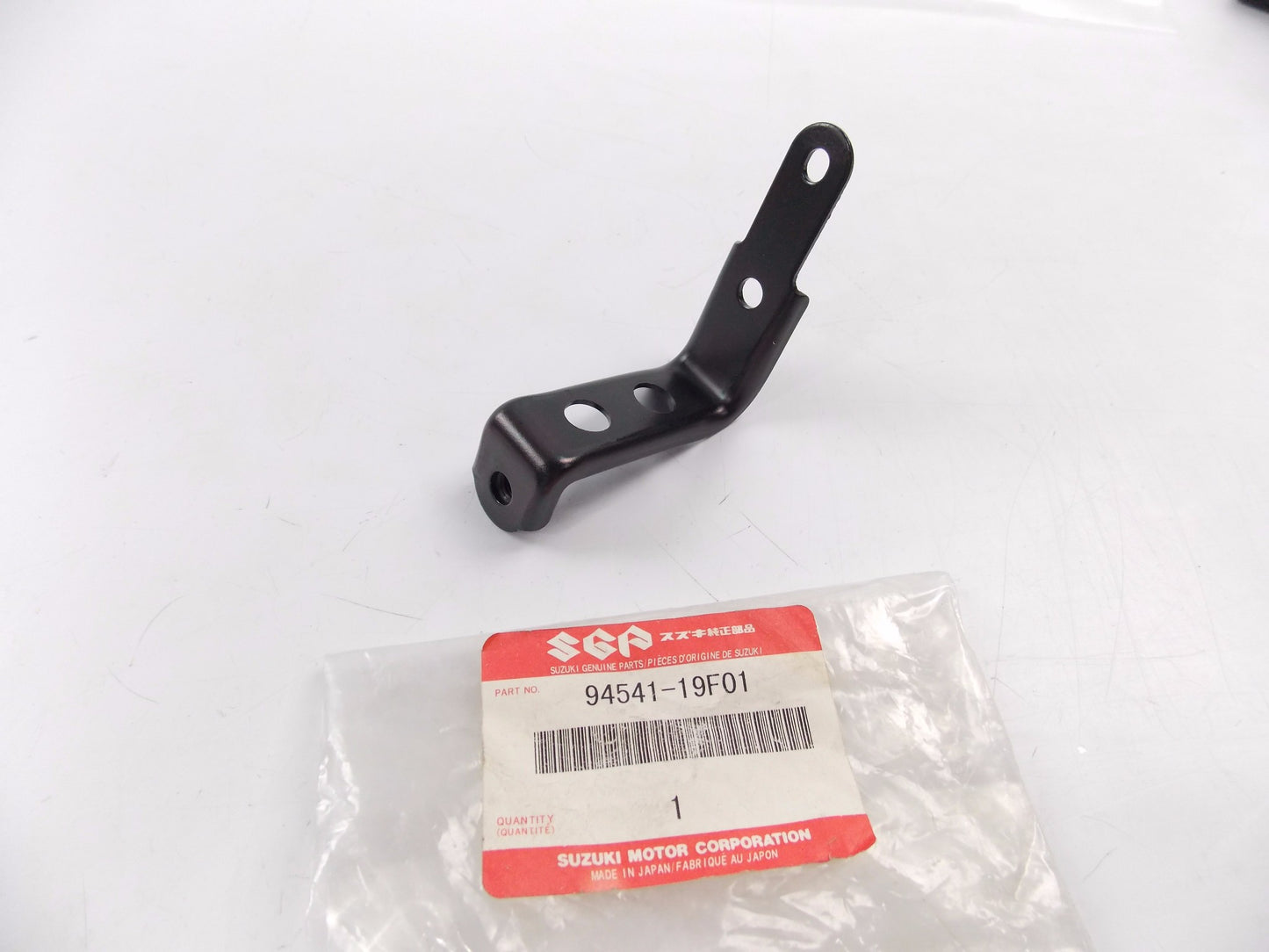 NOS OEM SUZUKI 1999-2002 SV650 SV650S BRACKET SIDE REAR LH 94541-19F01 - MotoRaider