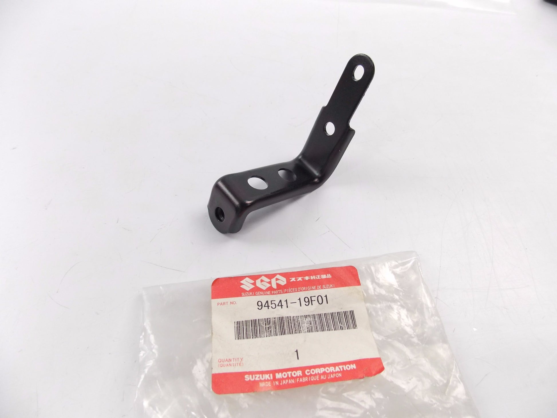 NOS OEM SUZUKI 1999-2002 SV650 SV650S BRACKET SIDE REAR LH 94541-19F01 - MotoRaider