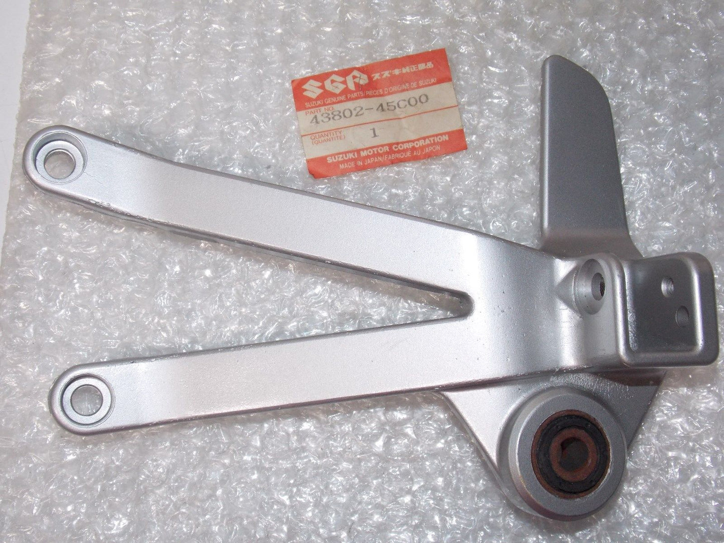 OEM SUZUKI 1990-1993 LEFT REAR FOOT REST BRACKET VX800 P  43802-45C00 - MotoRaider